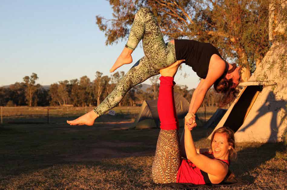 Three young people a woman and two men practice yoga partner in class on  background window Stock Photo - Alamy